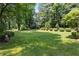 Serene backyard with lush green grass and manicured shrubbery offers an idyllic outdoor space at 4220 Singing Post Ne Ln, Roswell, GA 30075