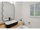 Modern bathroom with decorative mirror, stylish countertop sink, and plantation window shutters at 4220 Singing Post Ne Ln, Roswell, GA 30075