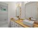 Modern bathroom with double vanity, gold fixtures and a shower/bath tub at 4220 Singing Post Ne Ln, Roswell, GA 30075