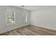 Bedroom featuring hardwood flooring, neutral paint, two windows and plantation shutters at 4220 Singing Post Ne Ln, Roswell, GA 30075