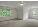Spacious bedroom with neutral carpet and windows overlooking a lush backyard at 4220 Singing Post Ne Ln, Roswell, GA 30075