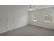 Bedroom features neutral carpet and large windows overlooking a lush backyard at 4220 Singing Post Ne Ln, Roswell, GA 30075