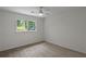 Bedroom featuring neutral walls, plush carpeting, a window and ceiling fan at 4220 Singing Post Ne Ln, Roswell, GA 30075
