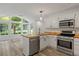 Charming kitchen with wood countertops, stainless steel appliances, and view of a green backyard at 4220 Singing Post Ne Ln, Roswell, GA 30075
