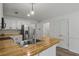 Bright kitchen features white cabinets, butcher block countertops, and stainless steel appliances at 4220 Singing Post Ne Ln, Roswell, GA 30075