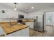 Updated kitchen featuring stainless steel appliances, a breakfast bar, and bright white cabinets at 4220 Singing Post Ne Ln, Roswell, GA 30075