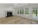 Living room with hardwood flooring, fireplace, and large windows at 4220 Singing Post Ne Ln, Roswell, GA 30075