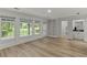 Sunlit living room with large windows overlooking the backyard, built-in shelving, and a bar area at 4220 Singing Post Ne Ln, Roswell, GA 30075