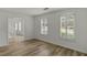 Bright living room with hardwood flooring, neutral paint, two windows and plantation shutters at 4220 Singing Post Ne Ln, Roswell, GA 30075