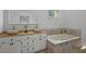 Bright main bathroom featuring double sinks and a soaking tub at 4220 Singing Post Ne Ln, Roswell, GA 30075