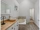 Main bathroom featuring double sinks, soaking tub, and bright natural light at 4220 Singing Post Ne Ln, Roswell, GA 30075
