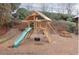 Outdoor playground with slide, tire swing, climbing wall, ladder, picnic table, and mulch ground cover at 4220 Singing Post Ne Ln, Roswell, GA 30075