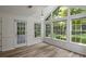 Sunroom with large windows offering scenic views and hardwood floors at 4220 Singing Post Ne Ln, Roswell, GA 30075