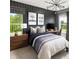 Charming bedroom featuring a sleek modern design with a dark accent wall and eye-catching decor at 6450 Pond View Dr, Cumming, GA 30028