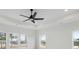 A bedroom featuring a ceiling fan and windows at 6450 Pond View Dr, Cumming, GA 30028