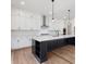 Modern kitchen with white cabinets, stainless steel appliances, and a large island at 6450 Pond View Dr, Cumming, GA 30028