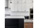 Modern kitchen with stainless appliances, white cabinets, a large island, and hardwood floors at 6450 Pond View Dr, Cumming, GA 30028