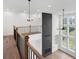 Bright loft features hardwood floors, black metal railing, and built in shelving at 6450 Pond View Dr, Cumming, GA 30028