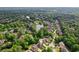 An aerial view of the neighborhood highlights lush greenery, ponds, and a suburban community at 952 Moores Walk Ln, Suwanee, GA 30024