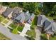 An aerial shot of the home features manicured lawns and mature trees in a suburban neighborhood at 952 Moores Walk Ln, Suwanee, GA 30024