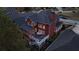 An aerial view of a brick home features its deck and landscaping in a suburban neighborhood at 952 Moores Walk Ln, Suwanee, GA 30024