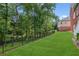 Serene backyard features a grassy lawn, privacy fence, and mature trees at 952 Moores Walk Ln, Suwanee, GA 30024