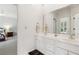 Bathroom with a double sink vanity, white cabinets, lots of counter space, and tile floors at 952 Moores Walk Ln, Suwanee, GA 30024