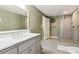 Modern bathroom with a marble countertop vanity and glass-enclosed shower at 952 Moores Walk Ln, Suwanee, GA 30024