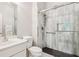 Modern bathroom with a glass shower, white tile surround, white fixtures, and silver hardware at 952 Moores Walk Ln, Suwanee, GA 30024