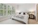 Comfortable bedroom with neutral paint, carpet, natural light, and a window with wooden shutters at 952 Moores Walk Ln, Suwanee, GA 30024