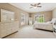 Bedroom featuring neutral walls, plantation shutters, a mirror, and lots of natural light at 952 Moores Walk Ln, Suwanee, GA 30024