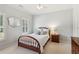 Bedroom with neutral walls, natural light, and a window with plantation shutters at 952 Moores Walk Ln, Suwanee, GA 30024