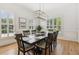 Elegant dining room featuring hardwood floors, decorative lighting, and large windows at 952 Moores Walk Ln, Suwanee, GA 30024