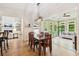 Open-concept dining room and living room with lots of natural light and hardwood flooring at 952 Moores Walk Ln, Suwanee, GA 30024