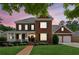 Beautiful two-story brick home with a welcoming front porch and well-manicured lawn at 952 Moores Walk Ln, Suwanee, GA 30024