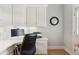 Bright home office with custom white cabinets, a built-in desk, and natural light at 952 Moores Walk Ln, Suwanee, GA 30024
