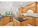 Bright eat-in kitchen features stainless appliances, granite counters, and a central island at 952 Moores Walk Ln, Suwanee, GA 30024