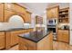 Traditional kitchen with granite countertops, stainless appliances, and custom wood cabinetry at 952 Moores Walk Ln, Suwanee, GA 30024