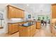 Open eat-in kitchen with granite countertops, a central island, and hardwood floors at 952 Moores Walk Ln, Suwanee, GA 30024