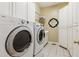 Spacious laundry room with washer, dryer, storage cabinets, and a utility sink at 952 Moores Walk Ln, Suwanee, GA 30024