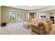 Relaxing living room with a comfortable neutral sofa, coffee table, and windows to the outside at 952 Moores Walk Ln, Suwanee, GA 30024