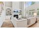 Bright and airy living room with hardwood floors, fireplace, built-in shelves, and large windows at 952 Moores Walk Ln, Suwanee, GA 30024