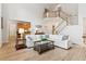 Bright open-concept living space with hardwood floors, a staircase, and a seamless connection to the kitchen at 952 Moores Walk Ln, Suwanee, GA 30024