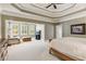 Large main bedroom showcasing trey ceilings, a sitting area, and lots of natural light at 952 Moores Walk Ln, Suwanee, GA 30024