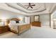 Spacious main bedroom featuring a trey ceiling, ceiling fan, and an ensuite bathroom at 952 Moores Walk Ln, Suwanee, GA 30024