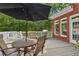 Outdoor patio with a dining table and chairs, an umbrella and barbecue at 952 Moores Walk Ln, Suwanee, GA 30024
