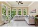 Cozy sunroom with neutral paint, tile floors, a comfortable seating area, and large windows at 952 Moores Walk Ln, Suwanee, GA 30024