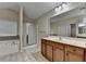 Bathroom features double vanity, tub, and glass-enclosed shower at 2280 Copper Trail Ln, Buford, GA 30519