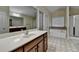 Bathroom with double sink vanity, soaking tub, and glass-enclosed shower at 2280 Copper Trail Ln, Buford, GA 30519