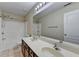 Bright bathroom with a double sink vanity, tub-shower combo, and large mirror at 2280 Copper Trail Ln, Buford, GA 30519